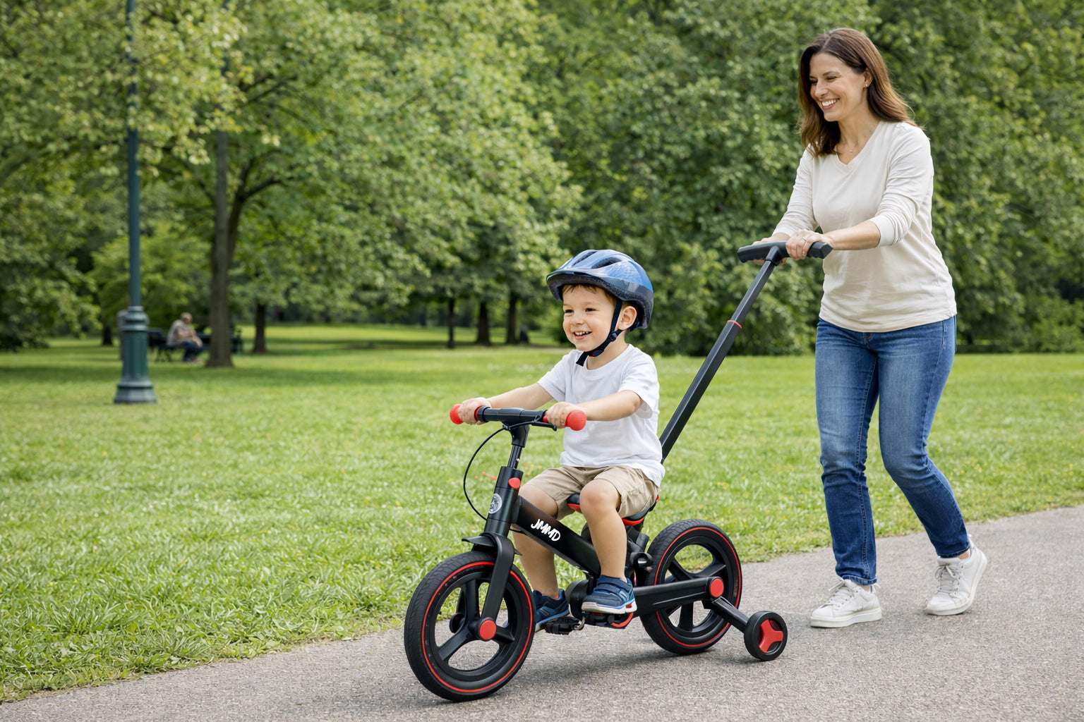 parent pushing toddler balance bike with push handle for safe control and learning to ride independently