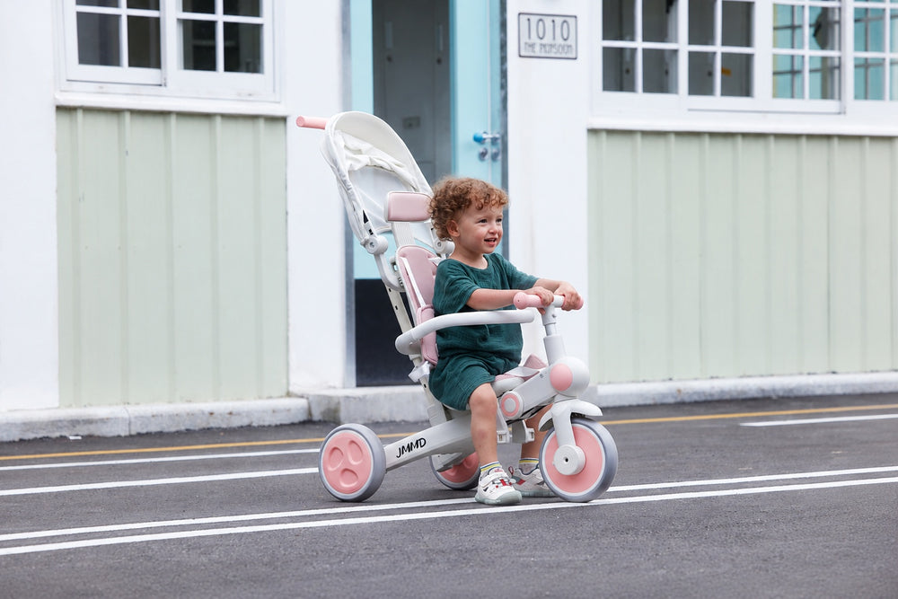 #color_all Child riding the JMMD A7 pink tricycle outdoors