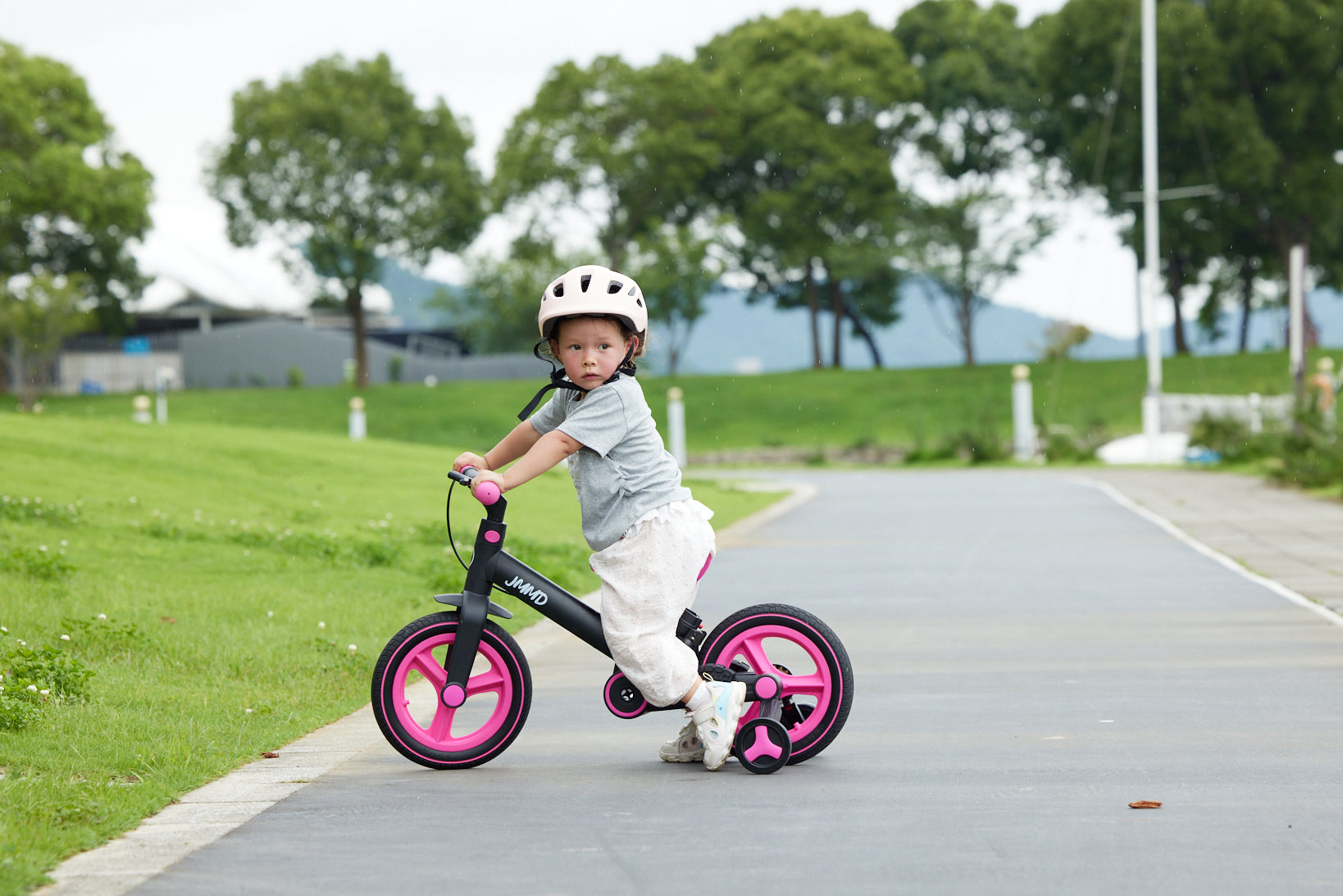#color_all Child riding a JMMD toddler bike outdoors for everyday family play