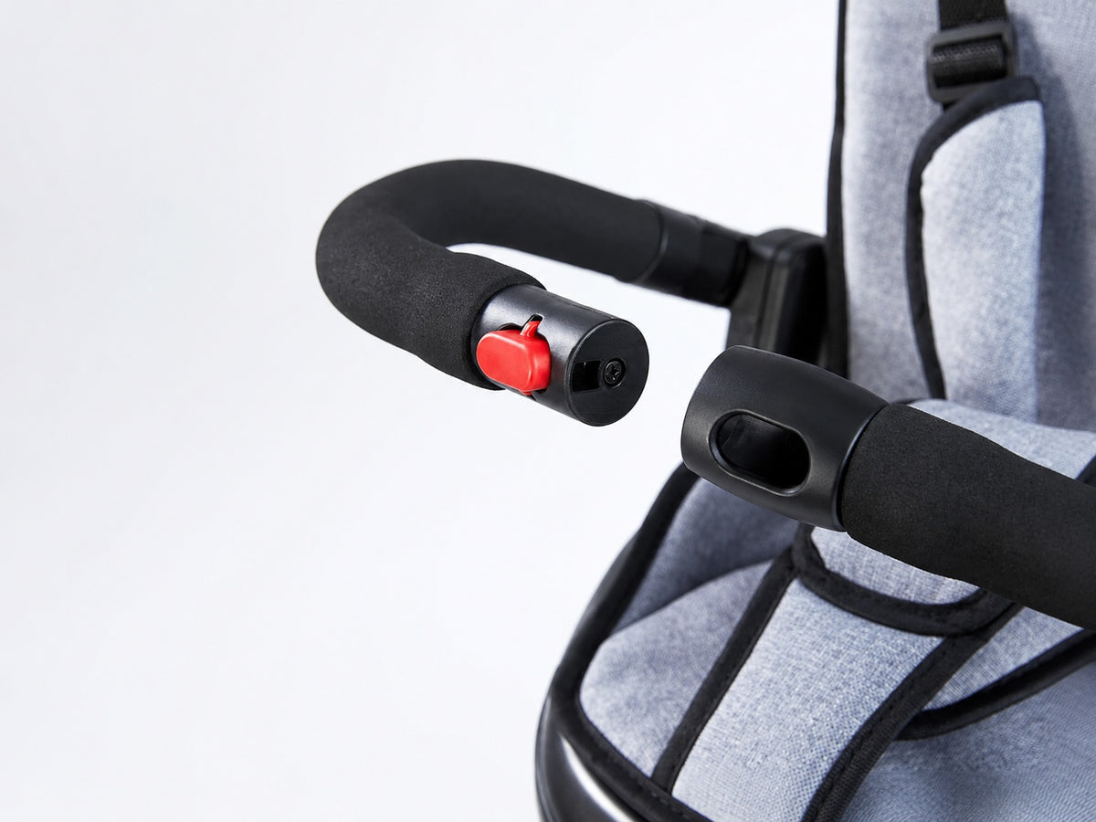 Close-up of the JMMD B56 removable safety guardrail with padded armrests and release button