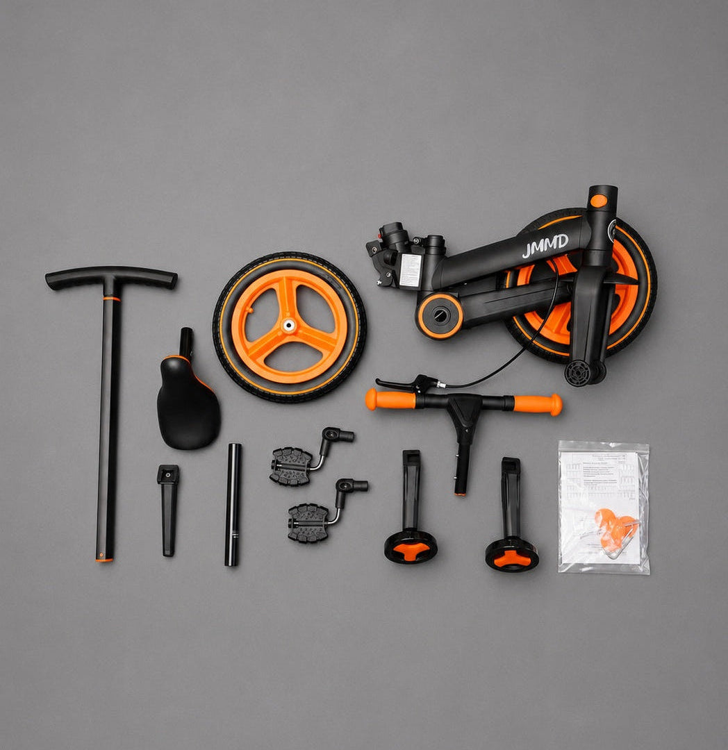 JMMD S900 kids trike parts and accessories arranged in a black and orange studio flat lay