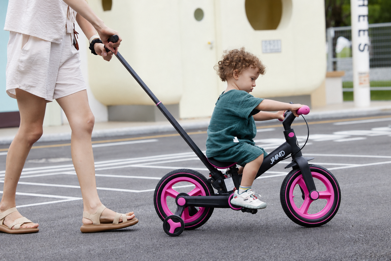 Child riding the JMMD S900 kids bike with parent handle outdoors