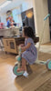 Toddler riding the JMMD A7 Folding Trike indoors with parent push handle and canopy