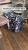 Toddler girl riding the JMMD S900 6-in-1 toddler bike indoors with parent assistance