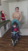 Toddler boy riding the JMMD B56 Family Trike indoors with parent push handle and canopy