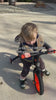 Toddler riding the JMMD S900 balance bike outdoors with grow-with-me design