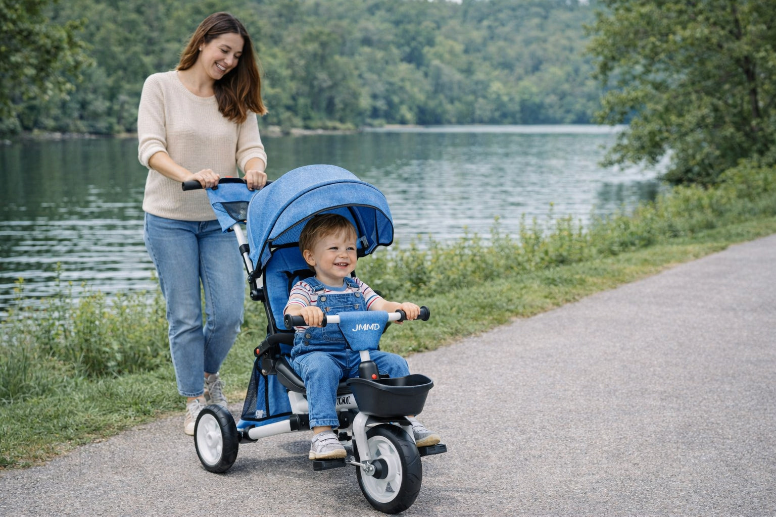 Mother pushing toddler tricycle in stroller mode with child sitting comfortably outdoors